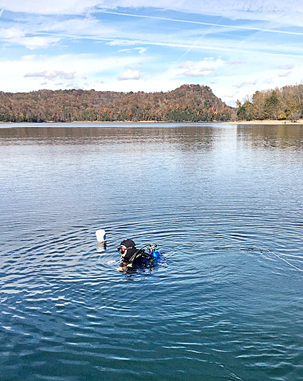 Tony Waters prepares to dive next to the buoy marking the stone's location.